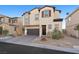 Two-story house with a dark brown garage door and landscaping at 6955 Sunrise Crest Dr, Las Vegas, NV 89142