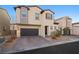 Two-story house with a dark brown garage door and landscaping at 6955 Sunrise Crest Dr, Las Vegas, NV 89142