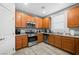 Modern kitchen with stainless steel appliances and wood cabinets at 6955 Sunrise Crest Dr, Las Vegas, NV 89142