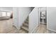 Modern staircase with light grey wood steps and white walls at 6955 Sunrise Crest Dr, Las Vegas, NV 89142