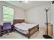 Cozy bedroom with a double bed, desk, and window coverings at 766 Topocoba St, Las Vegas, NV 89178