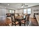 Well-lit dining area that blends with the living area, featuring wood floors, ceiling fan, and comfortable seating at 766 Topocoba St, Las Vegas, NV 89178