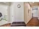 Bright hallway with wood floors, bench, and laundry room access at 766 Topocoba St, Las Vegas, NV 89178