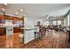 Open-concept kitchen with a breakfast bar, wood cabinets, and wood floors flows into the living area at 766 Topocoba St, Las Vegas, NV 89178