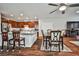 Well-lit kitchen featuring wood cabinets, stainless steel appliances, and a granite island connected to a dining area at 766 Topocoba St, Las Vegas, NV 89178