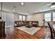 Spacious living room with a ceiling fan, a large leather sectional, and access to natural light through the window at 766 Topocoba St, Las Vegas, NV 89178