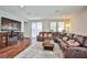 Living room with sectional sofa, fireplace, and large screen TV at 766 Topocoba St, Las Vegas, NV 89178
