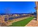 Landscaped backyard with artificial turf and a view of the surrounding community at 92 Stone Bluff Ln, Henderson, NV 89011