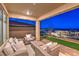 Covered patio with wicker furniture, offering scenic views and a relaxing atmosphere at 92 Stone Bluff Ln, Henderson, NV 89011