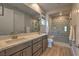 Modern bathroom with double vanity and patterned shower at 92 Stone Bluff Ln, Henderson, NV 89011