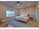 Comfortable bedroom with a queen-size bed and large window with mountain views at 92 Stone Bluff Ln, Henderson, NV 89011