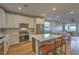 Open-concept kitchen with island and stainless steel appliances at 92 Stone Bluff Ln, Henderson, NV 89011