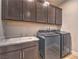 Laundry room with modern washer, dryer, and cabinets at 92 Stone Bluff Ln, Henderson, NV 89011