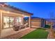 Covered patio with seating area and brick flooring at 92 Stone Bluff Ln, Henderson, NV 89011