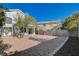 Spacious backyard with gravel landscaping, a pergola, and mature trees at 9309 Deer Lodge Ln, Las Vegas, NV 89129