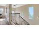 Upstairs hallway showcasing stylish light fixture and view to living area at 9309 Deer Lodge Ln, Las Vegas, NV 89129