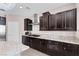 Dark wood kitchen cabinets and granite countertops at 9463 Belmont Bay Ave, Las Vegas, NV 89148