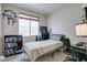 Small bedroom with bed, desk, and built-in shelving at 10605 Moon Flower Arbor Pl, Las Vegas, NV 89144