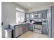 Updated kitchen featuring gray cabinets and stainless steel appliances at 10605 Moon Flower Arbor Pl, Las Vegas, NV 89144