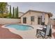 Private kidney-shaped pool and patio seating at 10605 Moon Flower Arbor Pl, Las Vegas, NV 89144