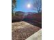 Sunny backyard with gravel and a block wall at 11193 Falesco Ave, Las Vegas, NV 89138