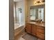 Bathroom with a bathtub, double vanity, and granite countertop at 11193 Falesco Ave, Las Vegas, NV 89138