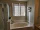 Bathroom with a bathtub and double window at 11193 Falesco Ave, Las Vegas, NV 89138