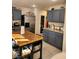 Kitchen with butcher block island and blue cabinets at 11193 Falesco Ave, Las Vegas, NV 89138