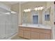 Bathroom with double sinks, shower, and light wood cabinets at 1647 Fieldbrook St, Henderson, NV 89052