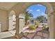 View through archway showing backyard access and neighborhood homes at 1647 Fieldbrook St, Henderson, NV 89052