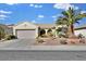 Front view of a single-story house with a two-car garage and palm trees at 1647 Fieldbrook St, Henderson, NV 89052