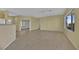 Spacious living room with light walls, wood-look flooring, and a ceiling fan at 1647 Fieldbrook St, Henderson, NV 89052