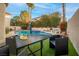 Inviting backyard oasis with pool, patio furniture, and lush landscaping at 179 Andada Dr, Henderson, NV 89012