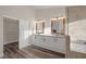 Bathroom with double vanity, granite countertop, and large mirrors at 179 Andada Dr, Henderson, NV 89012