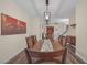 Elegant dining room with wood table and chairs, stylish light fixture at 179 Andada Dr, Henderson, NV 89012