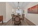 Bright dining room featuring a large table and modern light fixture at 179 Andada Dr, Henderson, NV 89012