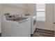 Convenient laundry room with washer, dryer, and shelving at 179 Andada Dr, Henderson, NV 89012