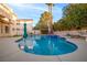 Relaxing kidney-shaped pool with tiled accents and ample surrounding space at 179 Andada Dr, Henderson, NV 89012