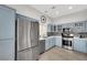 Modern kitchen with stainless steel appliances and light blue cabinets at 22 Arborfield Ct, Henderson, NV 89012