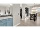 Eat-in kitchen with light blue cabinets and view to living room at 22 Arborfield Ct, Henderson, NV 89012