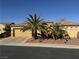 Attractive single-story home with a two-car garage, desert landscaping, and mature palm trees in the front yard at 2318 Shorewood Hills Ave, Henderson, NV 89052