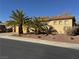 Single-story home featuring desert landscaping, mature palm trees, a two-car garage, and a tile roof at 2318 Shorewood Hills Ave, Henderson, NV 89052