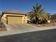 Charming single-story home with a two-car garage, desert landscaping, and tall palm trees in the front yard at 2318 Shorewood Hills Ave, Henderson, NV 89052