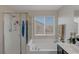 Bathroom with soaking tub, shower, and a large window at 2404 Briggsdale Ave, North Las Vegas, NV 89081