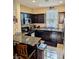 Kitchen with dark wood cabinets and granite countertops at 2404 Briggsdale Ave, North Las Vegas, NV 89081