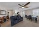 Living room with reclining sofa, dining area, and ceiling fan at 2404 Briggsdale Ave, North Las Vegas, NV 89081