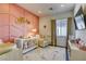 Adorable Bedroom featuring a crib, armchair, and accent wall at 2576 Desante Dr, Henderson, NV 89044