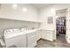 Bright laundry room with washer, dryer, and cabinets at 2576 Desante Dr, Henderson, NV 89044