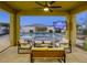 Covered patio with seating area and fire pit overlooking a sparkling pool at 2576 Desante Dr, Henderson, NV 89044