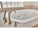 A jetted bathtub features a brushed nickel faucet and accent jets, and a tile window at 2617 Huber Heights Dr, Las Vegas, NV 89128